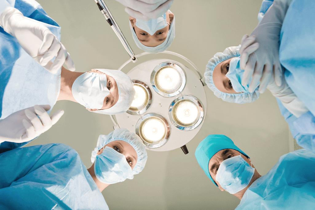 surgeons circling patient